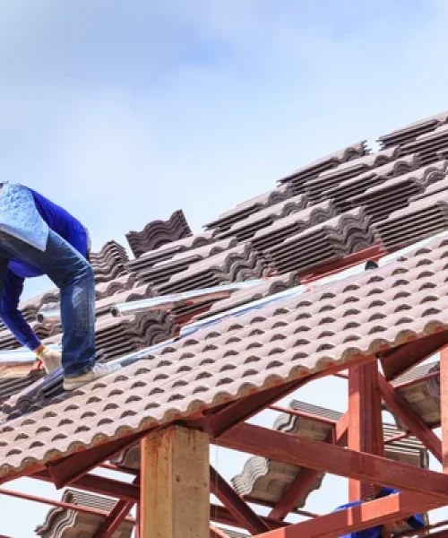 depositphotos_53426633-stock-photo-workers-install-roof-tile-for